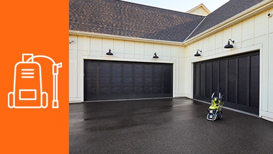 Driveway with a pressure washer by the garage door