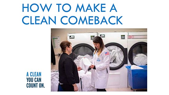 Ecolab technician reviewing the quality of laundry with an employee in a laundry room.