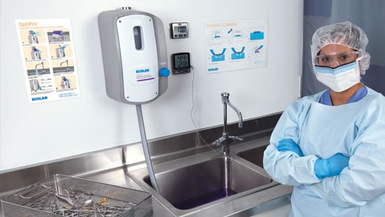 Central Sterile Department Worker Standing in front of the OptiPro Solid Manual Cleaning System
