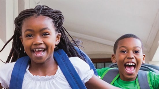 Two kids smiling as they run - Ecolab’s No/Low Maintenance Flooring Cleaner