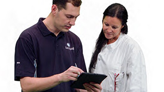 Bioquell technician showing a lab employee a clipboard