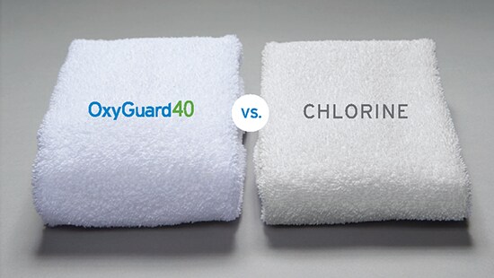 Comparing two white towels: Cleaner/Brighter on the left (OxyGuard) vs. yellowish towel on the right (chlorine)