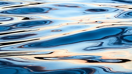 Water ripples in a lake at sunset