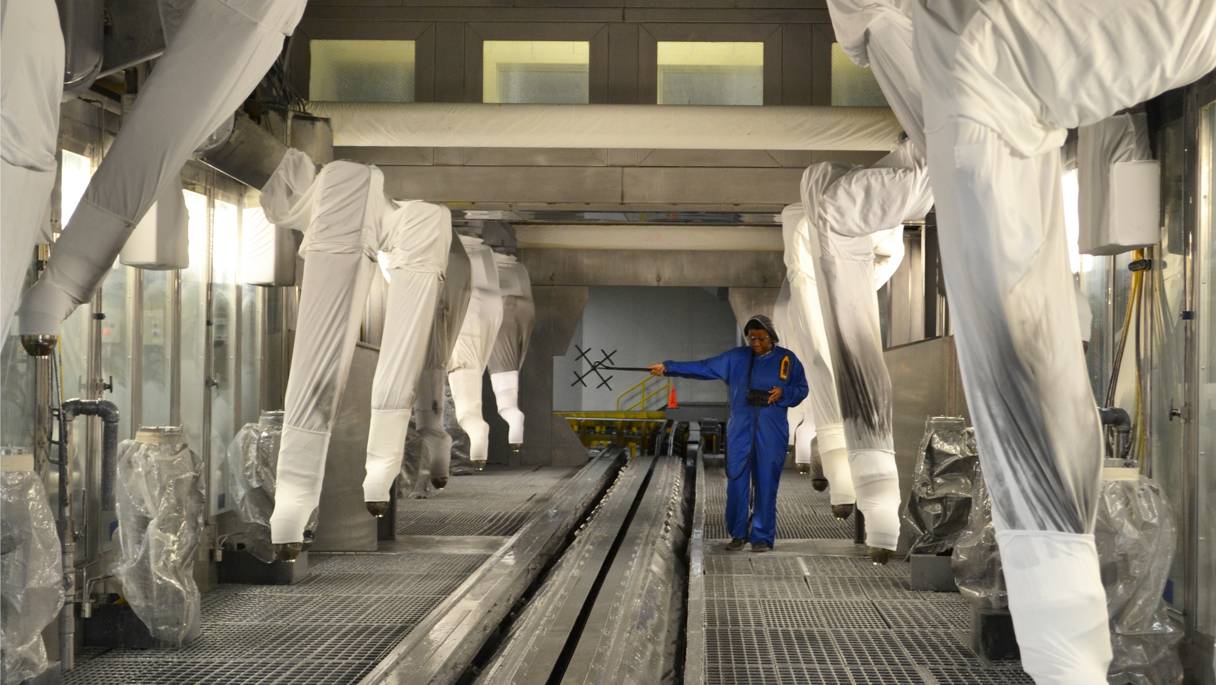 paint booth expert in automotive paint booth taking air flow measurements 