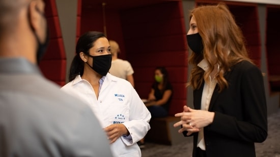 Women wearing masks talking