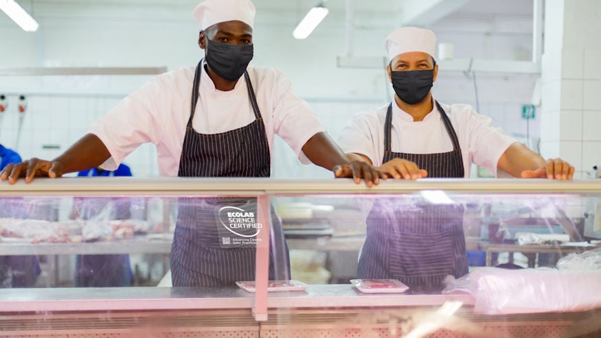 Butchers at an Ecolab Science Certified counter