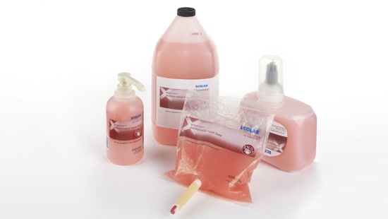 Assortment of Medi-Stat antimicrobial soap refill bottles and a hand pump model by Ecolab.