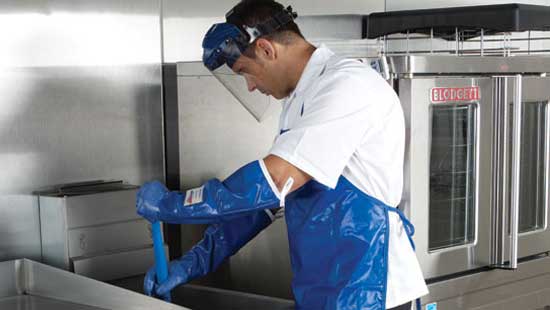 Man Cleaning a fryer using food safety PPE
