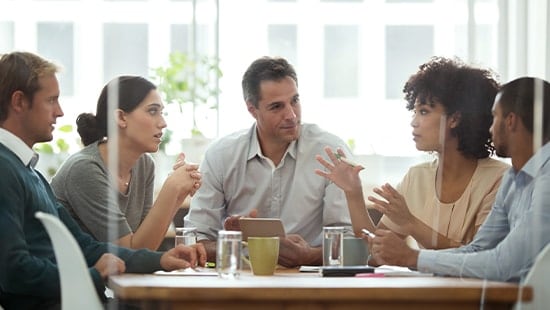 Group of people sitting at a table talking