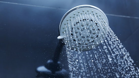  Showerhead with water flowing from it. 