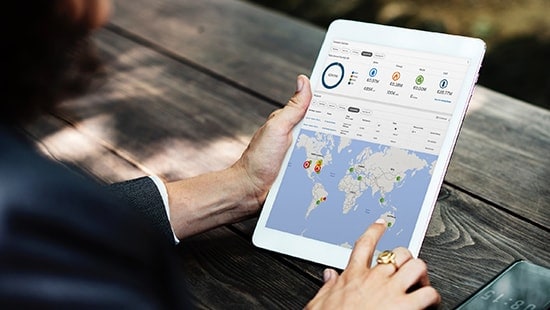 Close up of person's hands holding tablet interacting with ECOLAB3D interface.