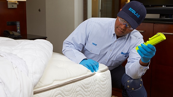 Service Specialist inspecting a mattress.