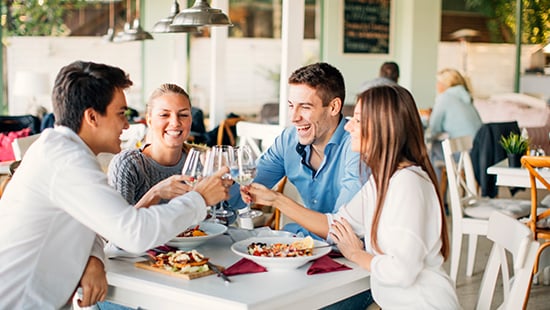 People out to eat sitting around a table.