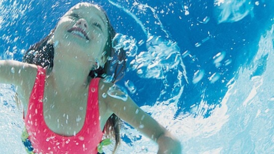 Young Girl Swimming in Clean Pool younggirlswimmingincleanpool