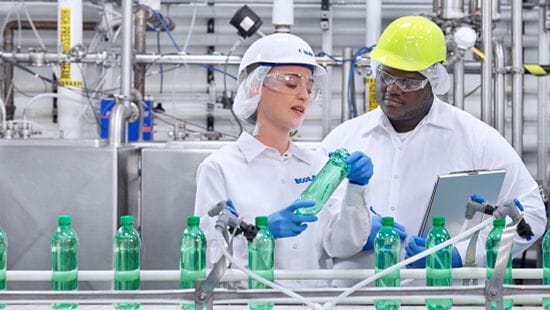 Ecolab associate and a food processing bottle line customer helping with water management.