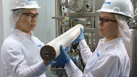 Male and Female Experts Holding Membrane