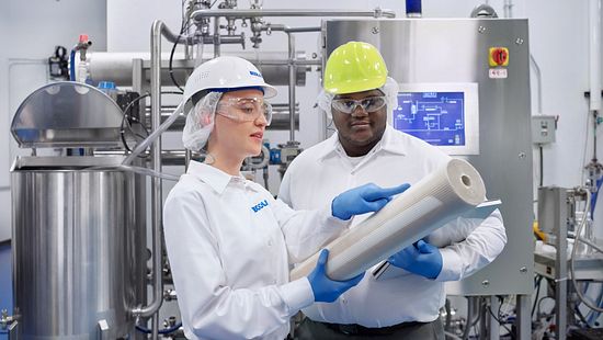 F&B Female Account Manager with Customer examining membrane next to membrane skid