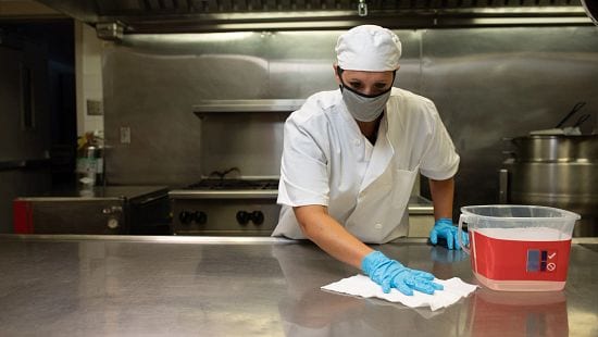 Chef with Sink & Surface Cleaner Sanitizer Visual Compliance System in use wiping counter