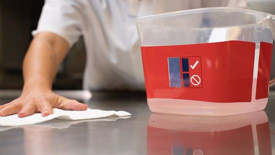 Chef with Sink & Surface Cleaner Sanitizer Visual Compliance System in use wiping counter