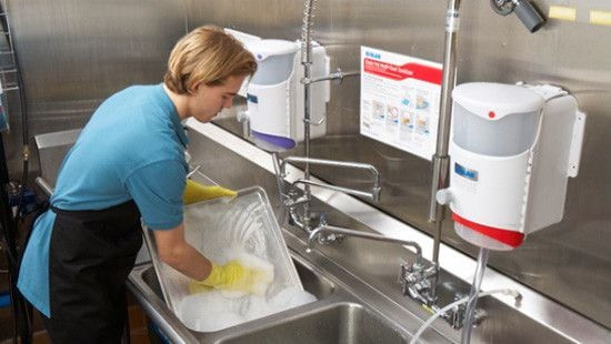 Employee_Washing_Dishes Front of house restaurant staff cleaning a table.