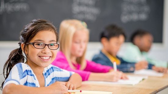 Young girl sitting in school class room