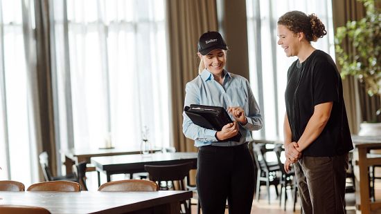 EcoSan Rep with manager in restaurant with tablet