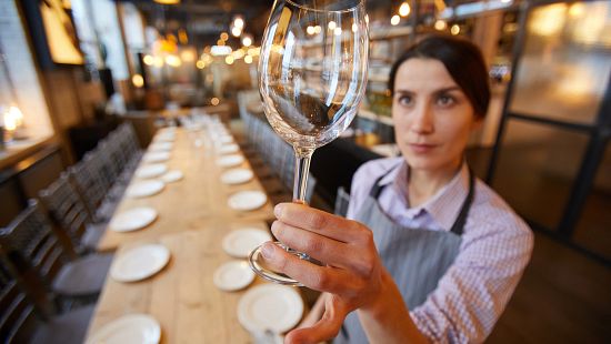 Front of house restaurant staff cleaning a table.