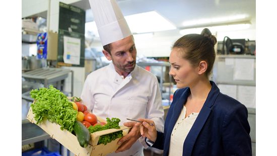 Kitchen inspector and chef inspecting food