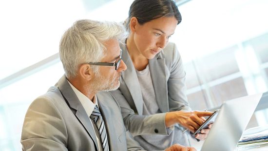 Two professionals reviewing data