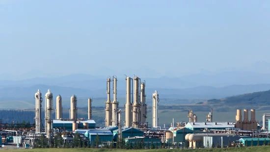 gas plan in front of mountains