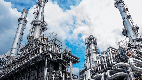 Close up Industrial view at oil refinery plant with blue sky and a few clouds