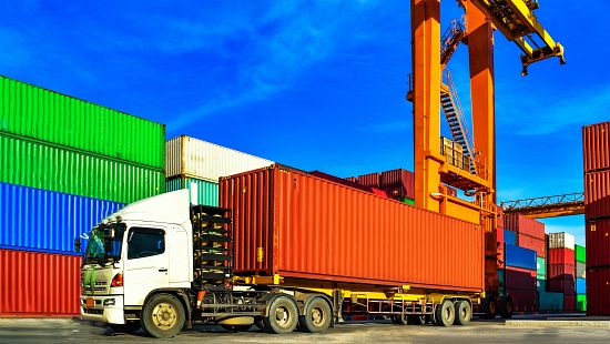 Truck picking up cargo container