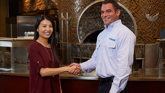 pest service representative shaking hands with woman customer